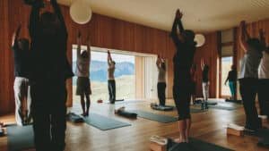 Group yoga session with panoramic alpine views at Aro Hā Wellness Retreat in New Zealand